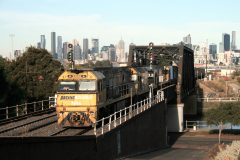 Freight train crossing Maribyrnong River and soon entering Bunbury Street Railway Tunnel