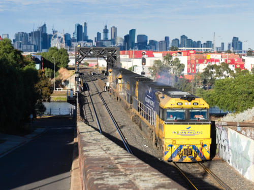 1 Indian Pacific and 2 Pacific National locos cross the bridge over Maribyrnong river before entering the Bunbury Street Tunnel (19.5.2019)